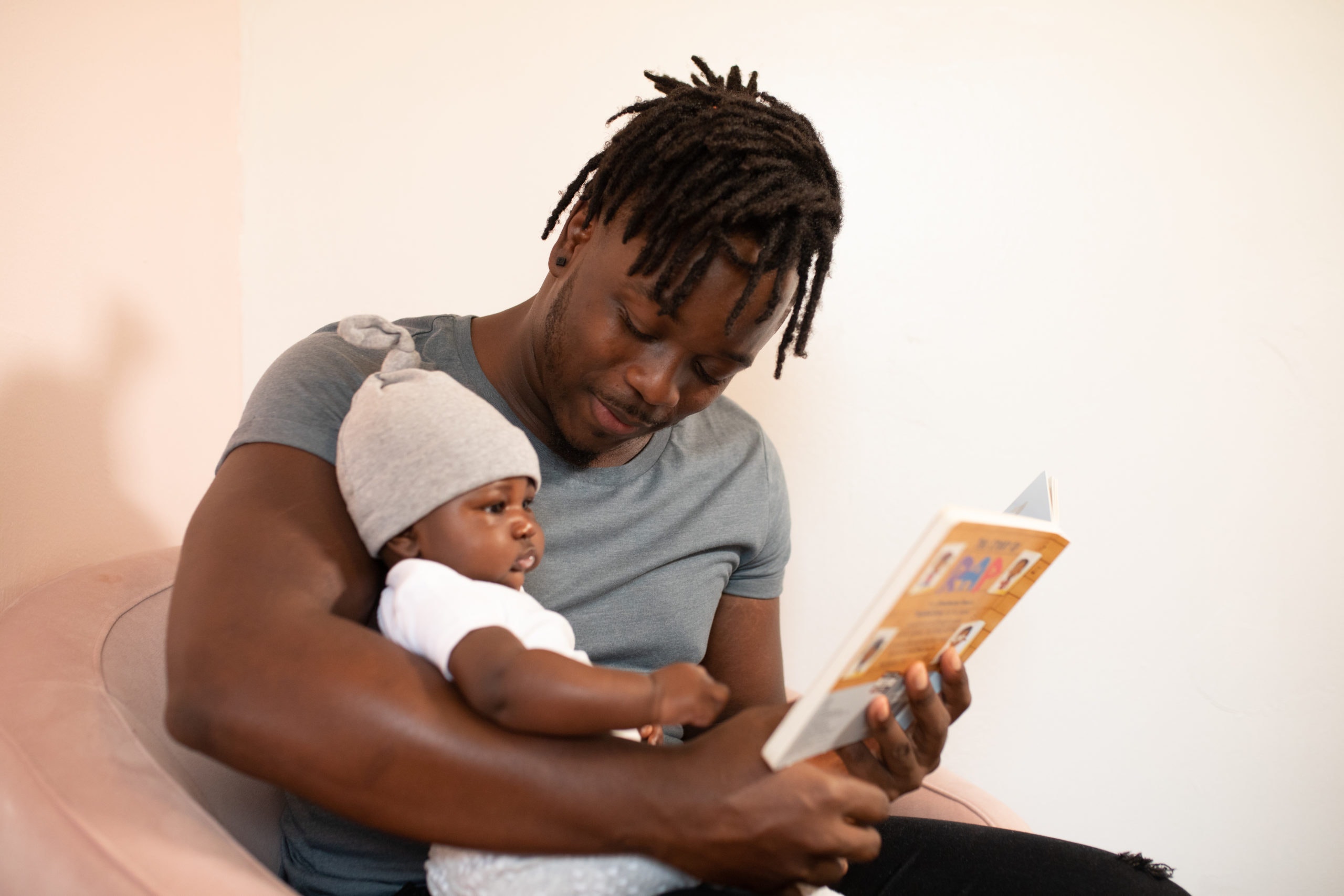 black father reading to a baby