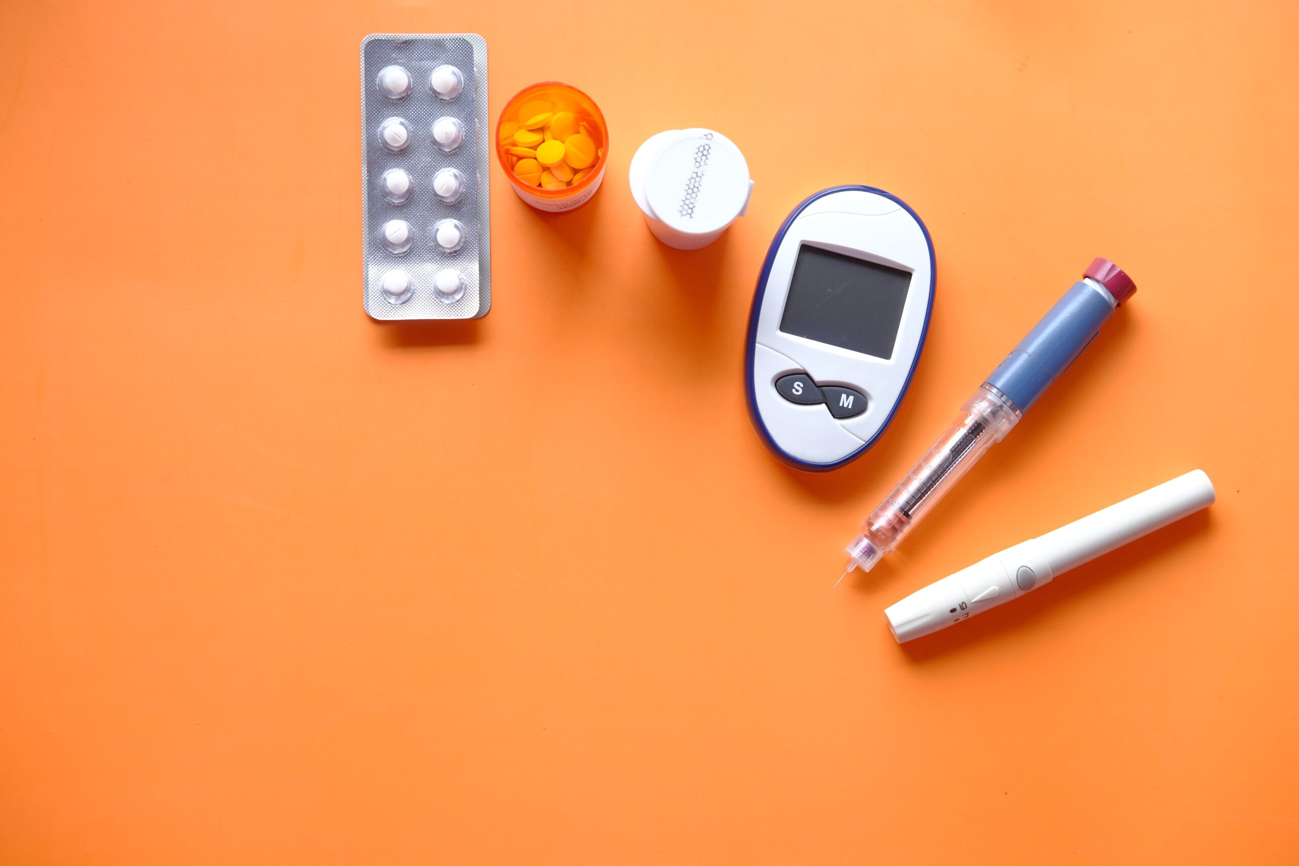 insulin pen, diabetic measurement tools, and pills