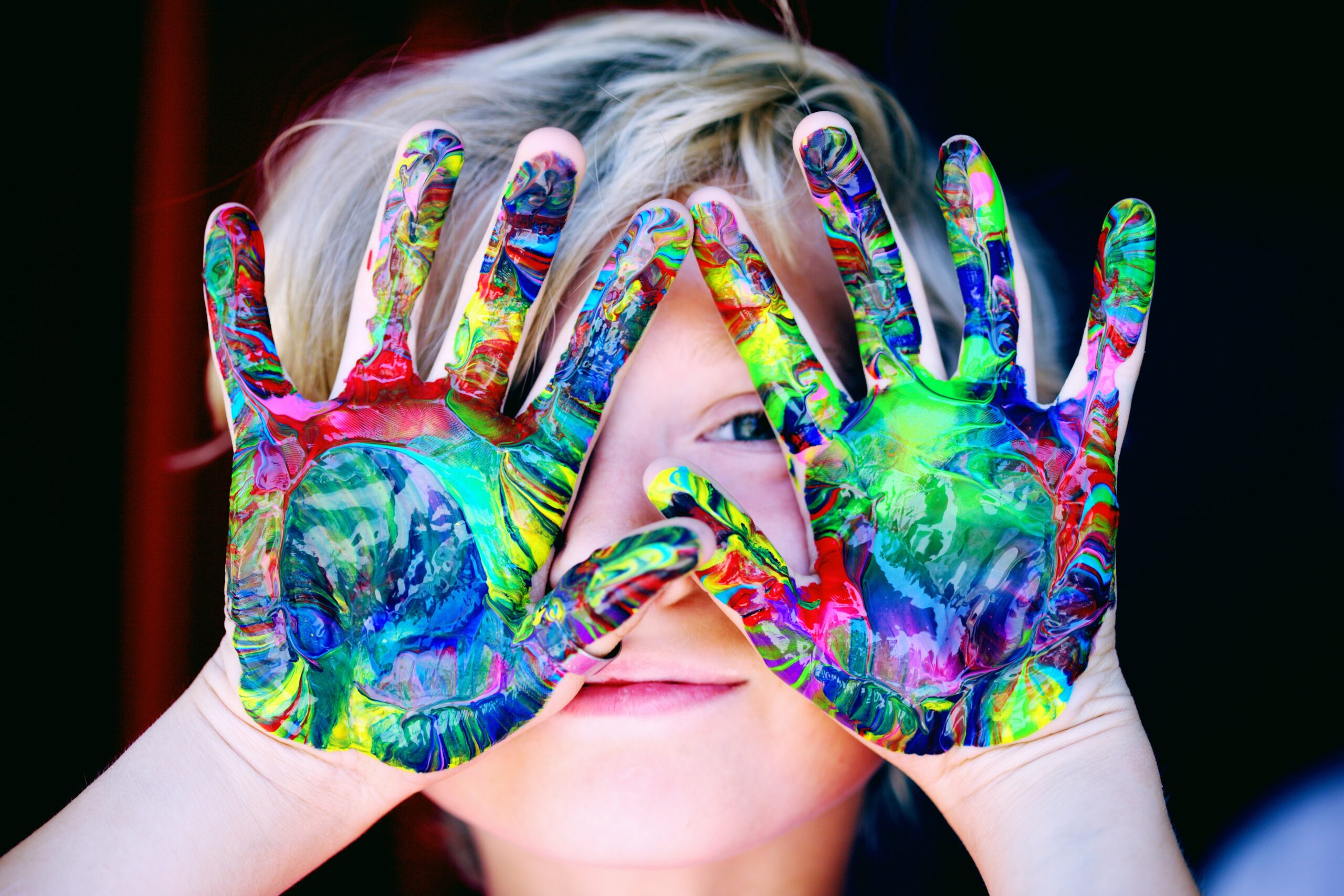 A child showing painted palms for 10 life skills to teach your child by age 10