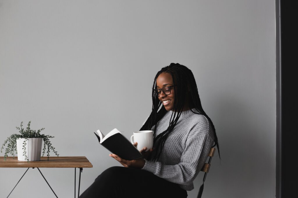Woman smiling while reading a book
