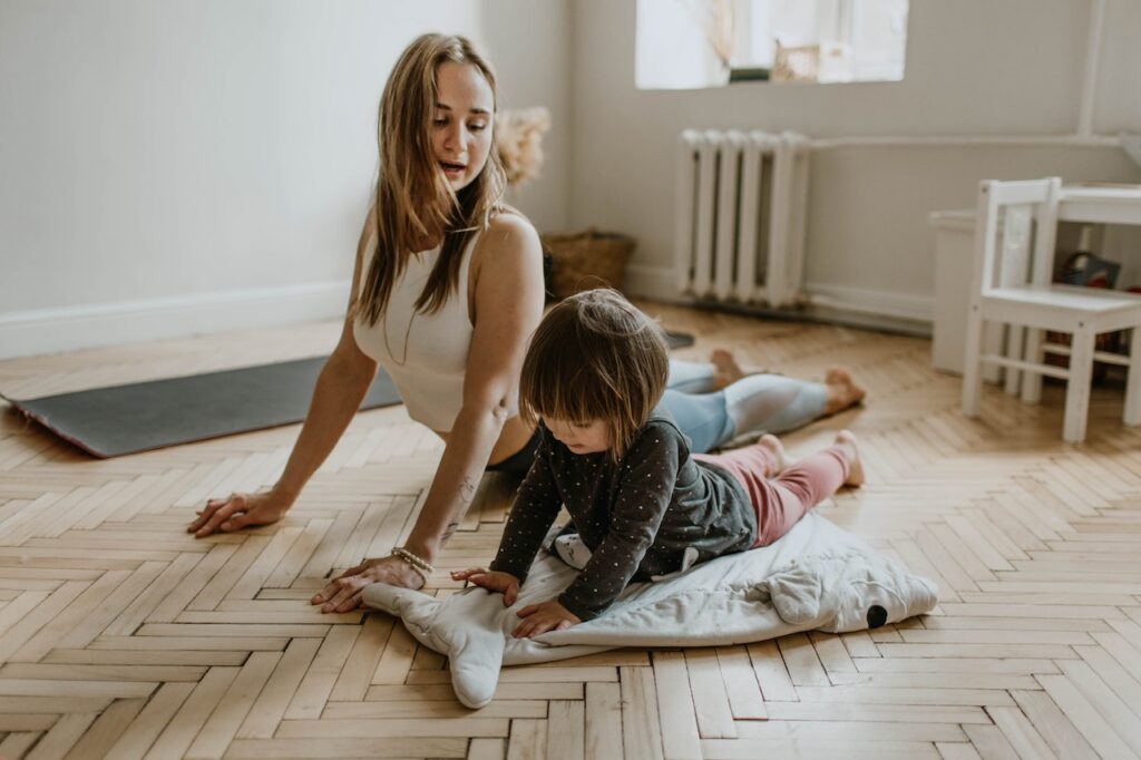 Mother and daughter doing yoga together on the floor as an example of supporting emotional
wellbeing in children with type 1 diabetes