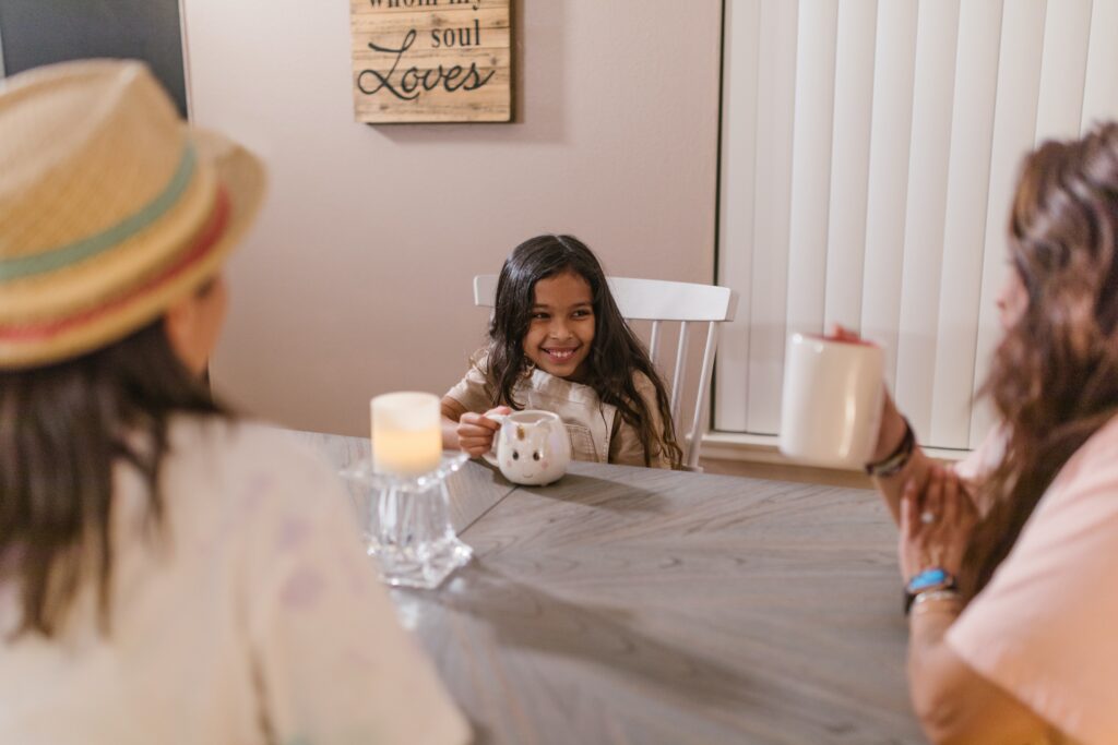 Parents sitting and talking with a little girl